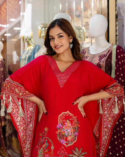 Woman wearing a red embroidered dress with a patterned shawl in a store setting.
